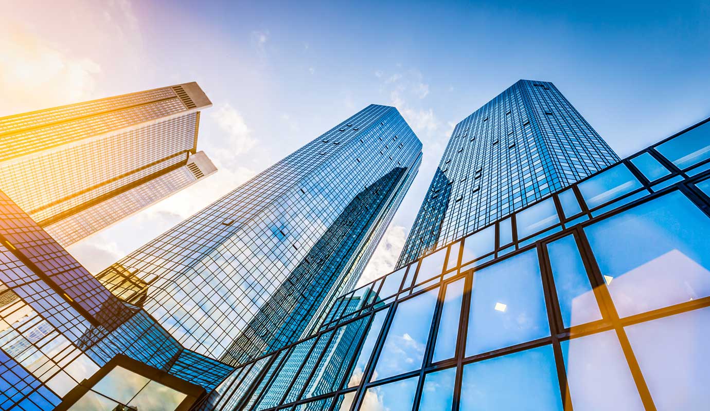 Bottom view of three skyscrapers 